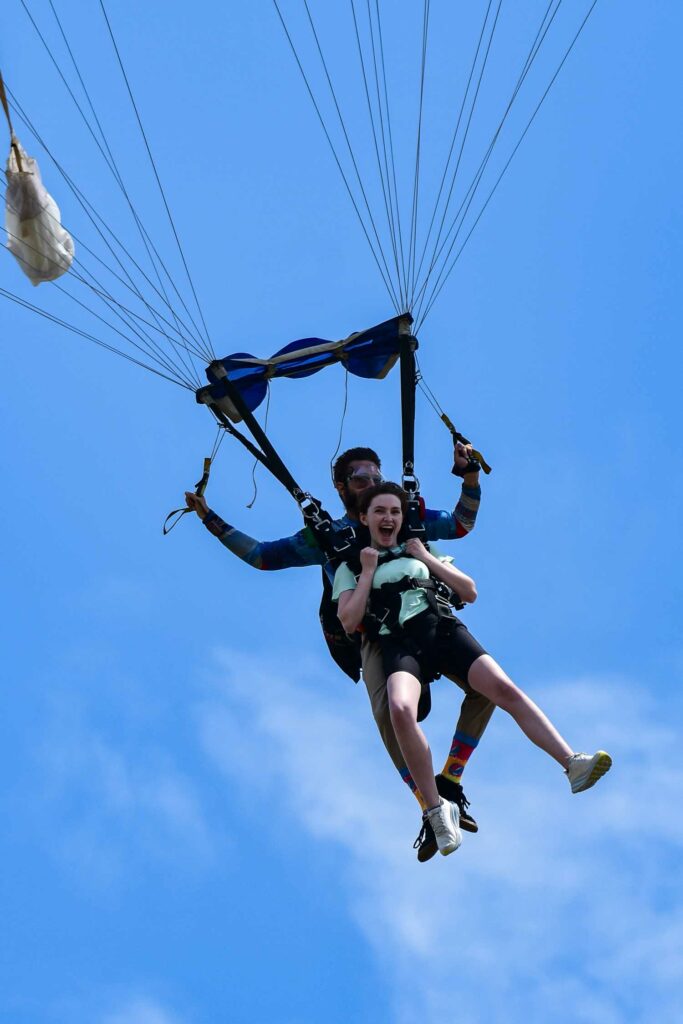 tandem skydivers come in for landing